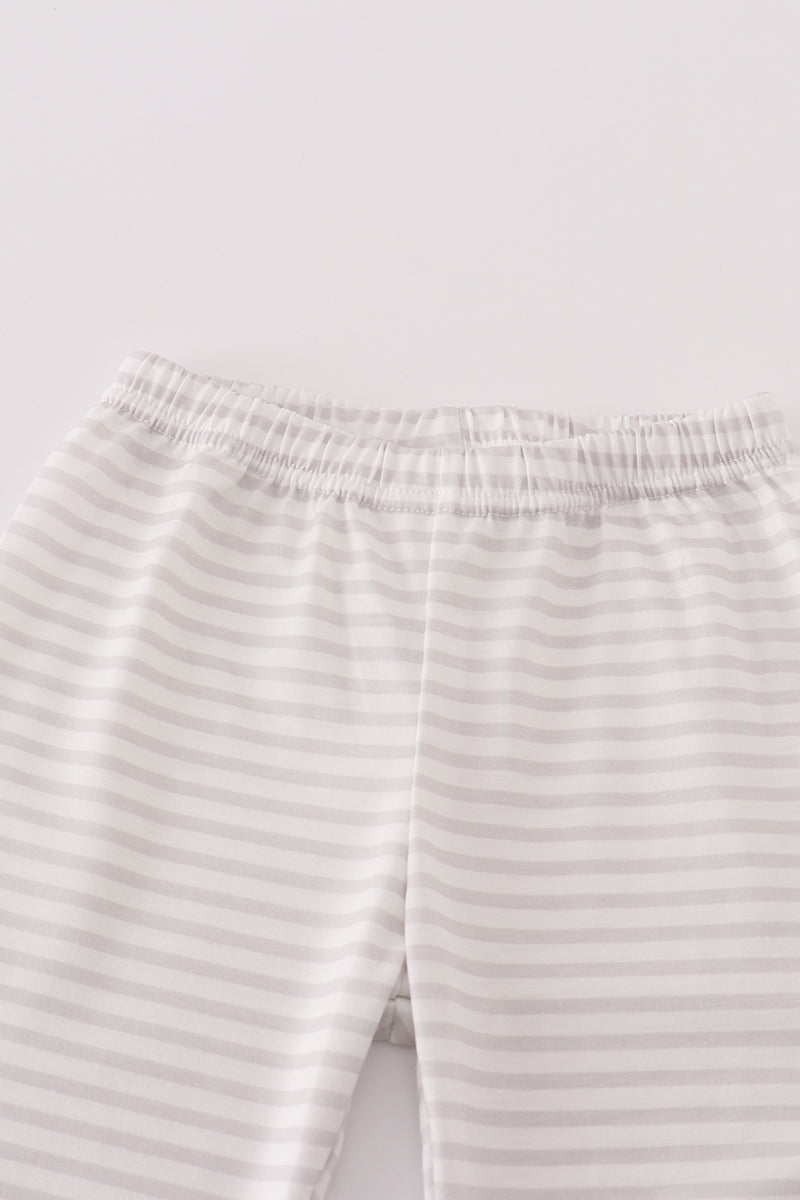Close-up of striped pants on a light gray background