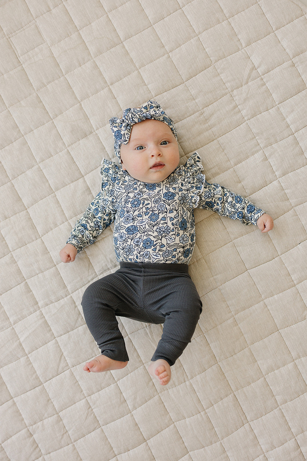 infant floral romper with long sleeves and snap closure