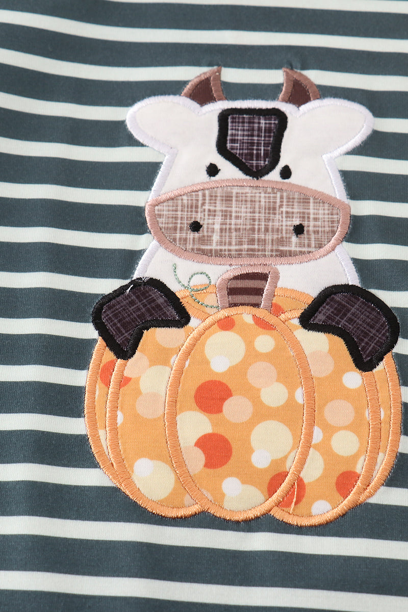 Cow-themed patch on a striped dress