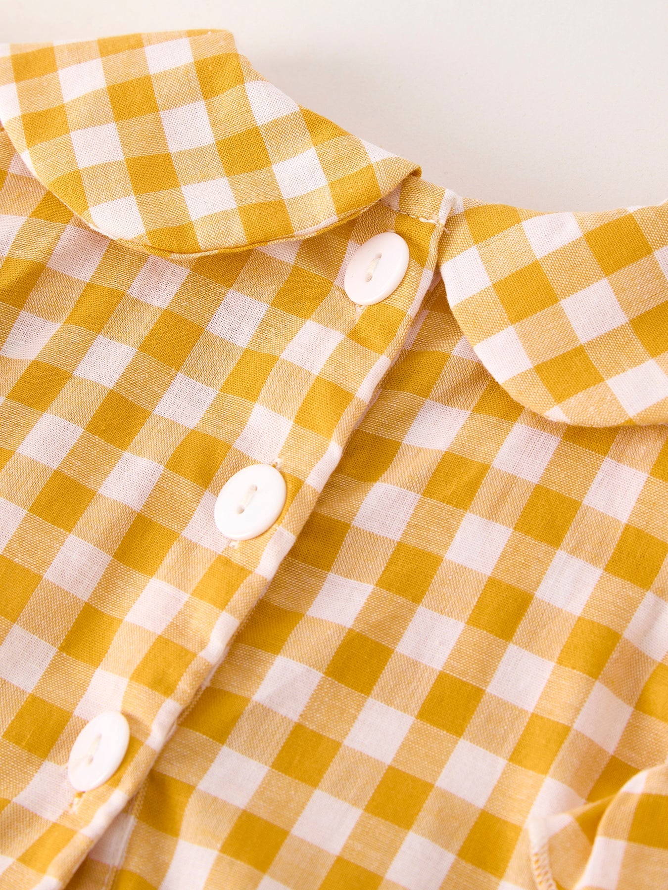 Girls yellow gingham Thanksgiving smocked dress with embroidered pumpkins, turkey, ruffle sleeves, and bow accents.