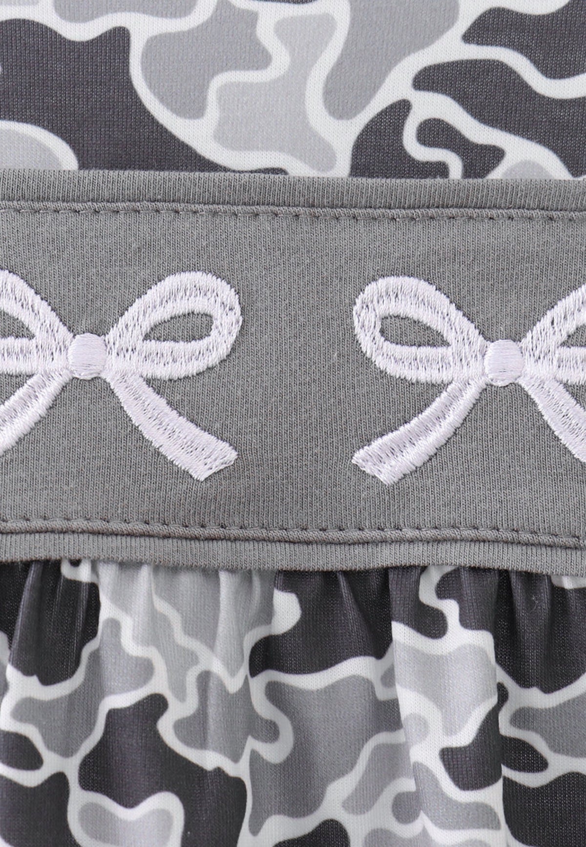 Gray camouflage bubble romper for baby girls with ruffle flutter sleeves and embroidered bow accents