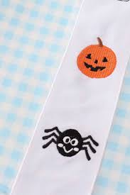 pajamas with pumpkin and spider design on a checkered background for toddler boys