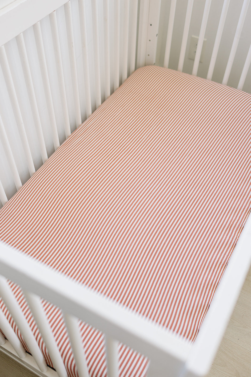Pink Stripes Muslin Crib sheet on crib - soft cotton baby bedding
