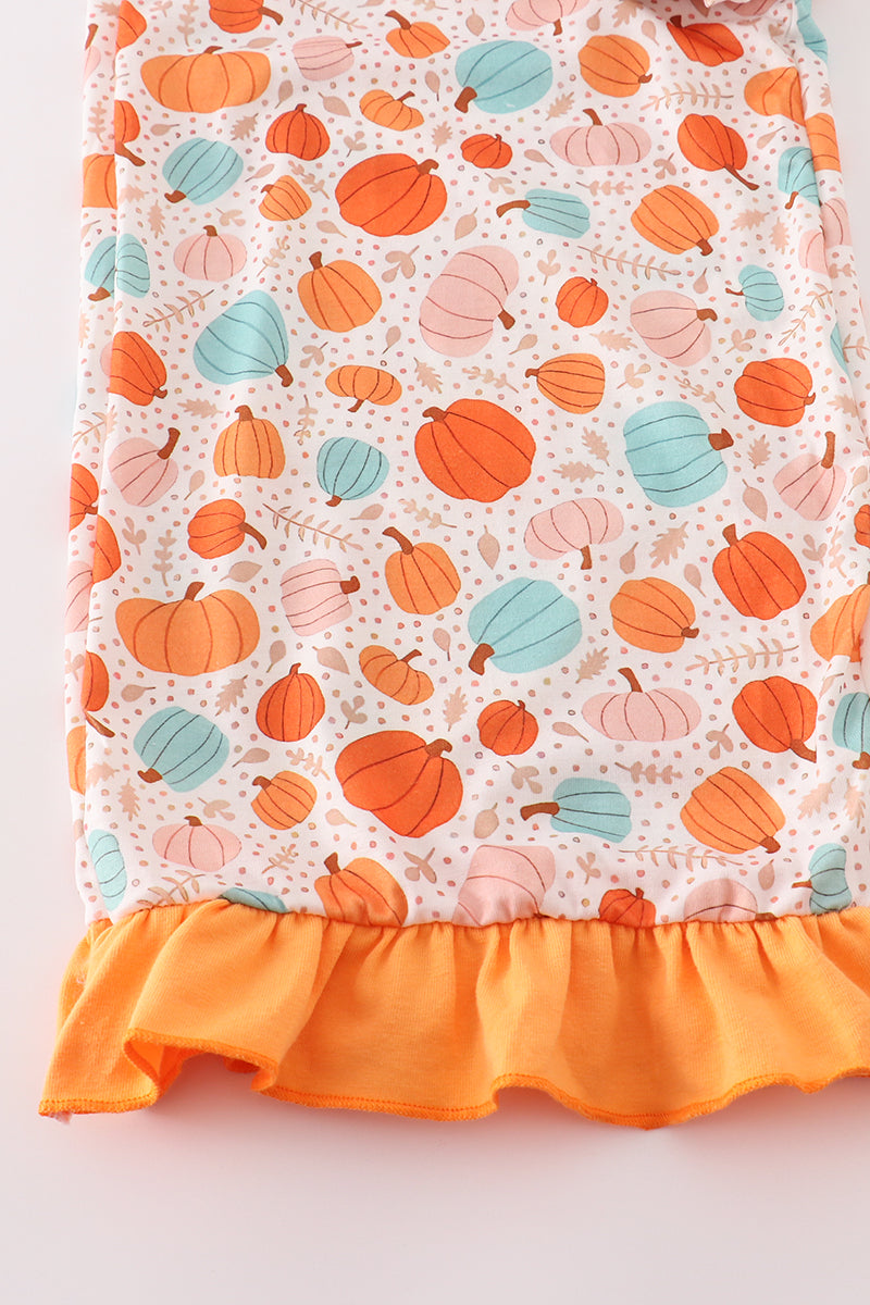pants with colorful pumpkin pattern and orange ruffled edge on a white background