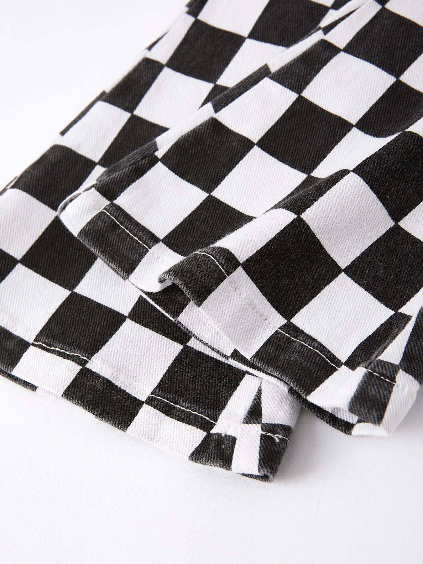 Close-up of a black and white checkered fabric on a white background