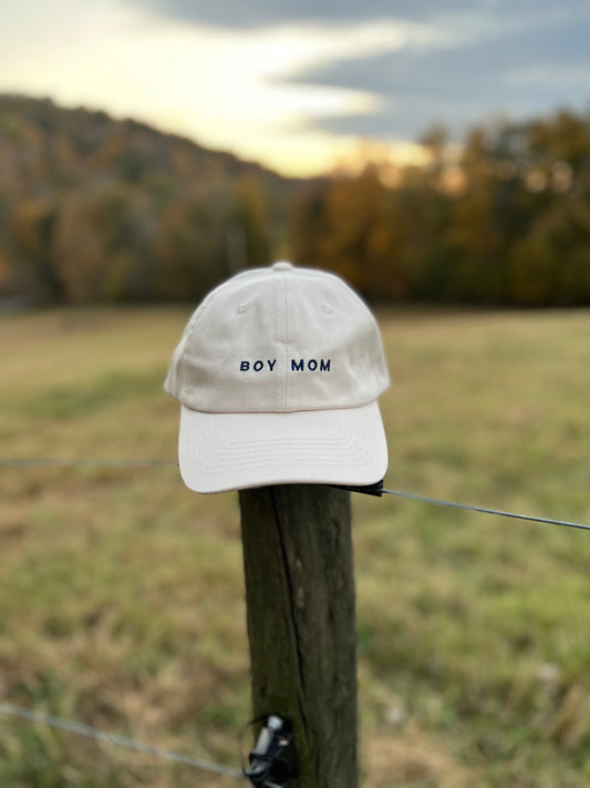 Cream baseball cap with navy embroidered lettering "boy mom" 