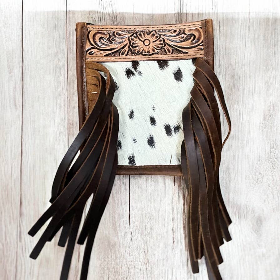 Kids purse with fringe and cowhide texture on a wooden background