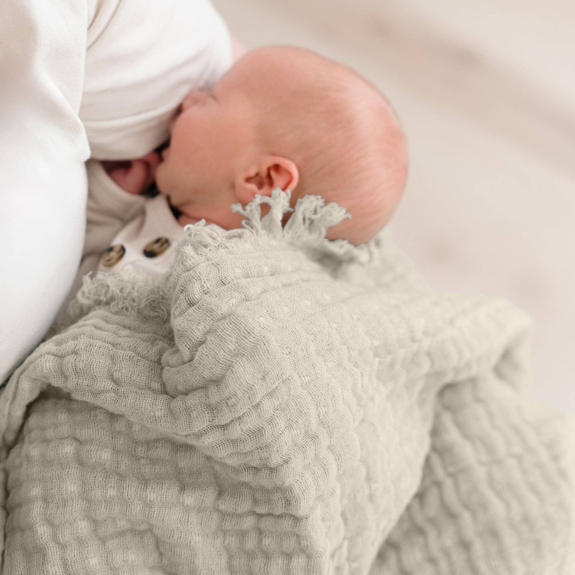 Neutral dove grey muslin baby blanket featuring subtle ombre design