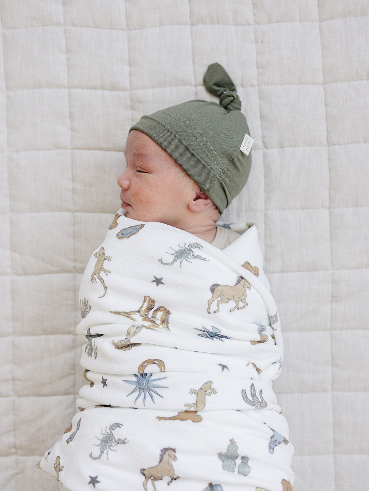 Up close photo of western themed swaddle for newborn baby boy