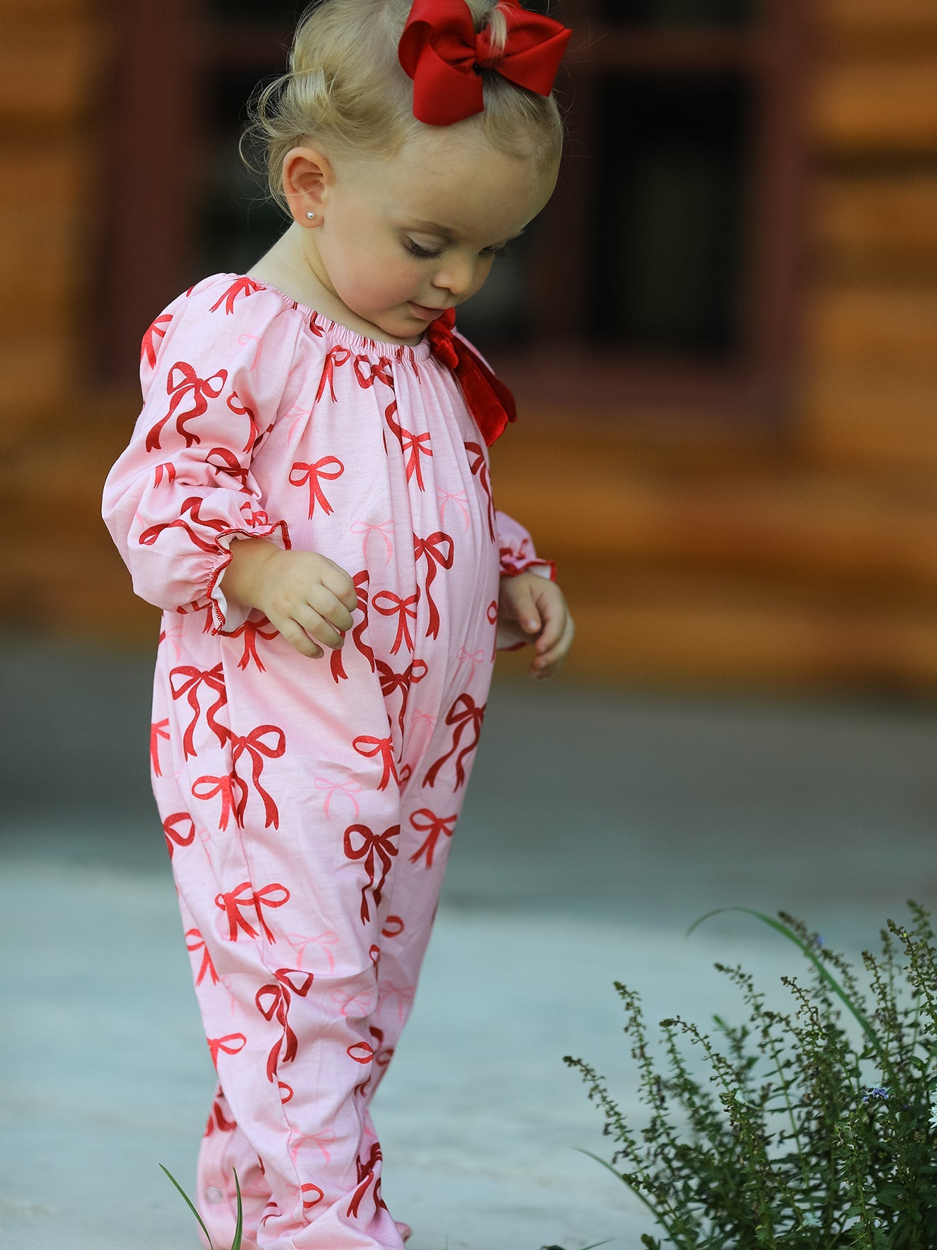 Holiday bow print romper for toddlers and infants