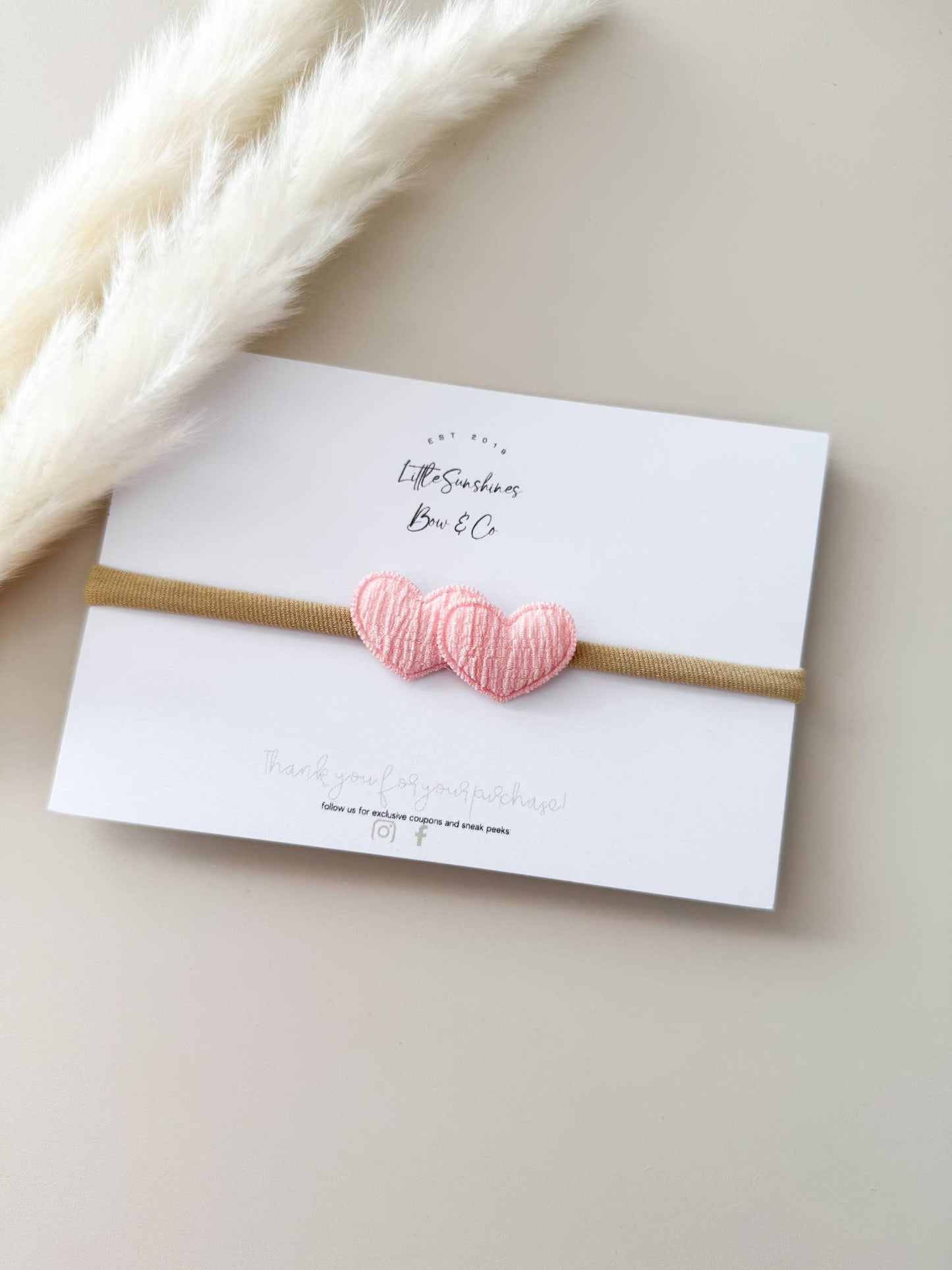 Pink heart baby headband with soft nylon band, lightweight and stretchy for newborns and toddlers