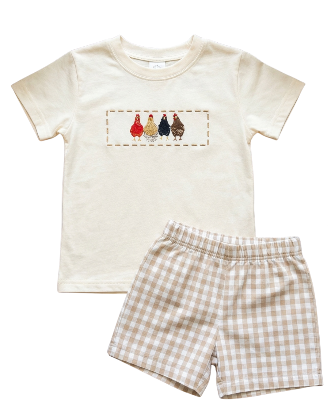 Flat lay toddler boys farm outfit with embroidered chicken shirt and beige gingham shorts on solid white background