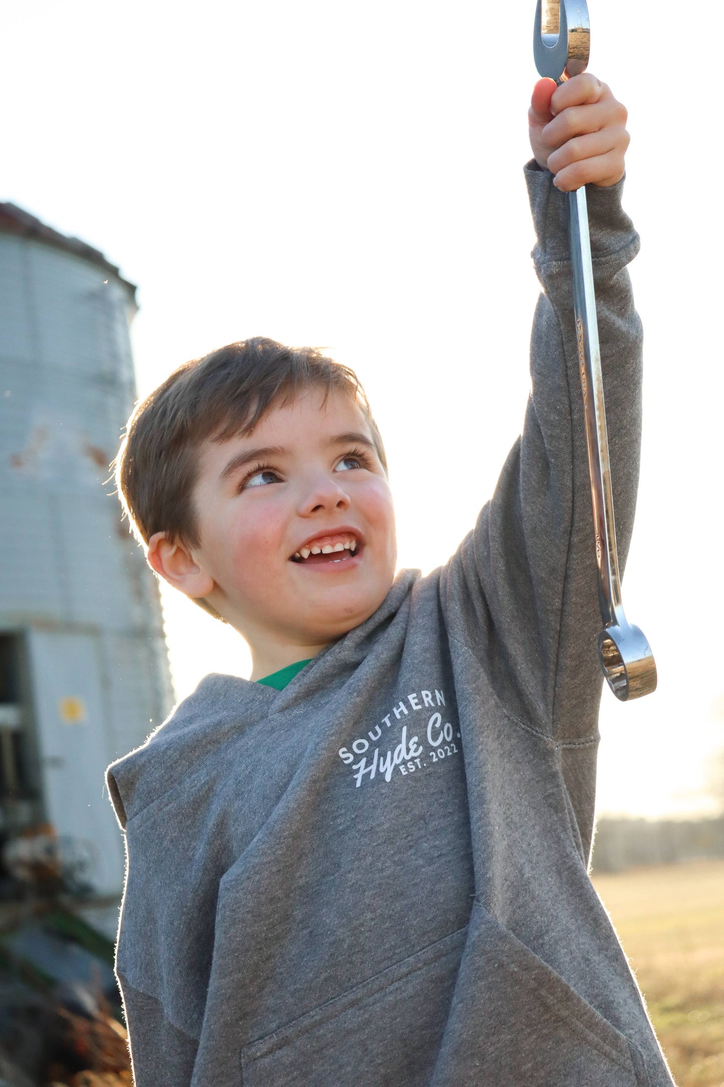 Child wearing Southern Hyde Blue Collar Mentality gray kids hoodie outdoors
