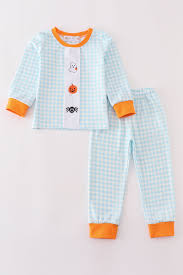 Blue gingham Halloween pajama set with orange trim and ghost, pumpkin, and candy corn details on the top.
