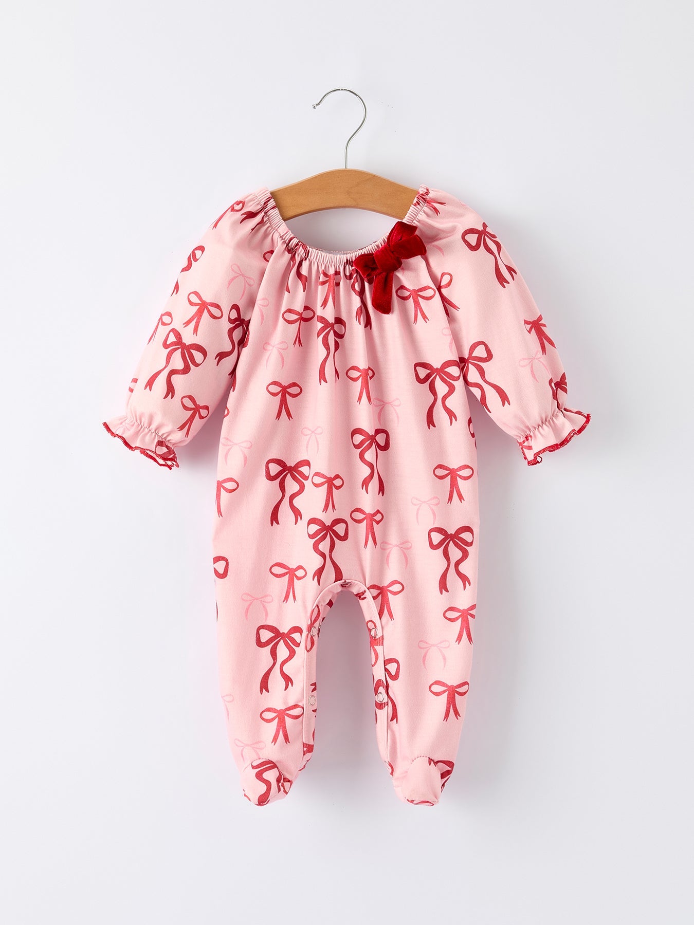 Festive baby romper with velvet bow neckline