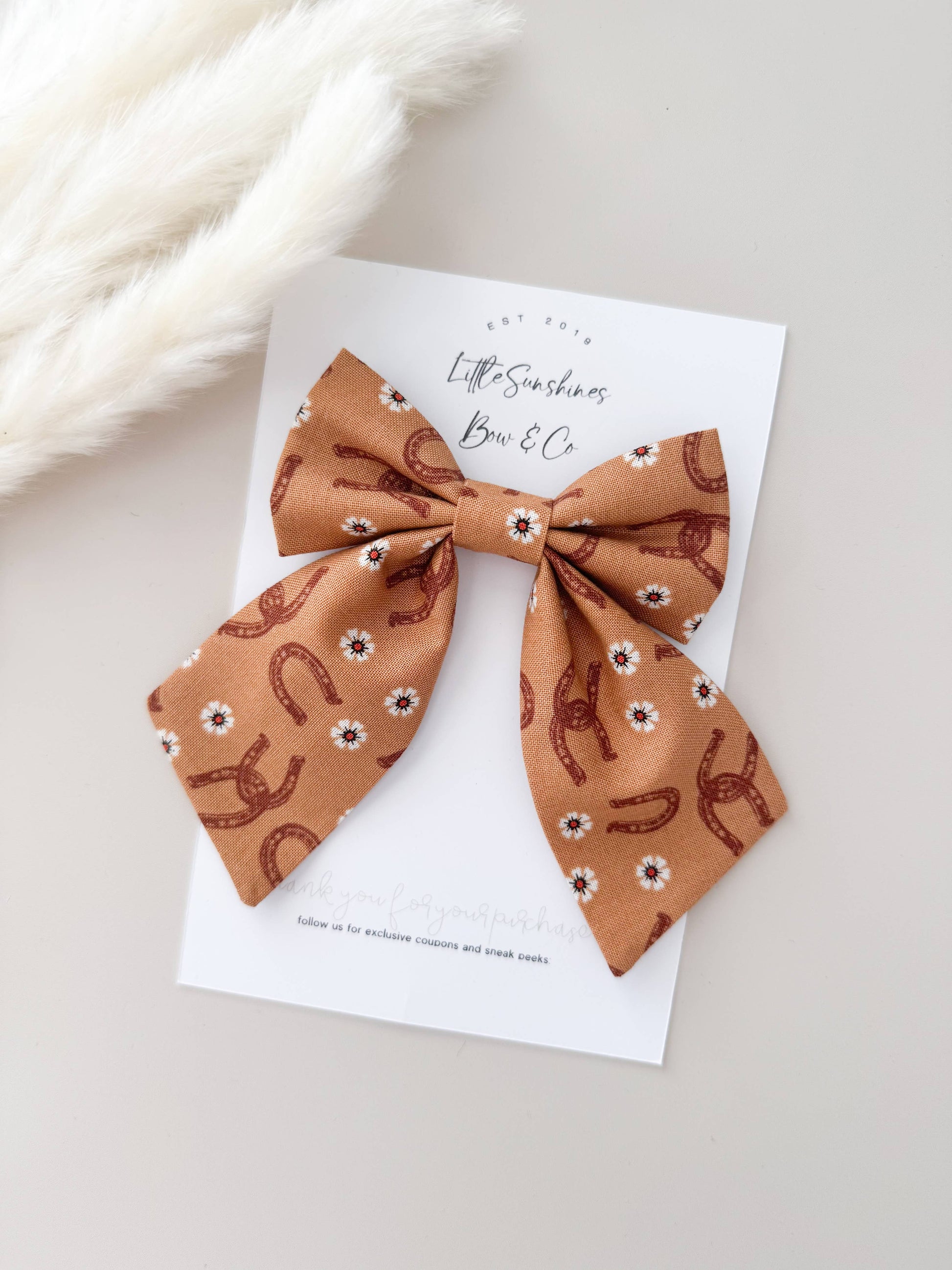 Western horseshoe bow clip with floral print on neutral fabric, lightweight hair bow for girls